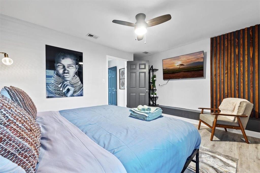 2659 Glenvalley Drive Decatur, GA 30032 - Photo 54 of 59 a bedroom with a bed and a flat screen tv