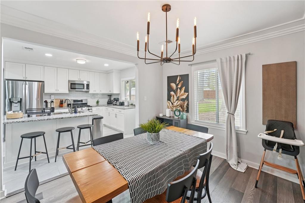 2659 Glenvalley Drive Decatur, GA 30032 - Photo 9 of 59 a kitchen with stainless steel appliances granite countertop a kitchen island a stove a table and chairs