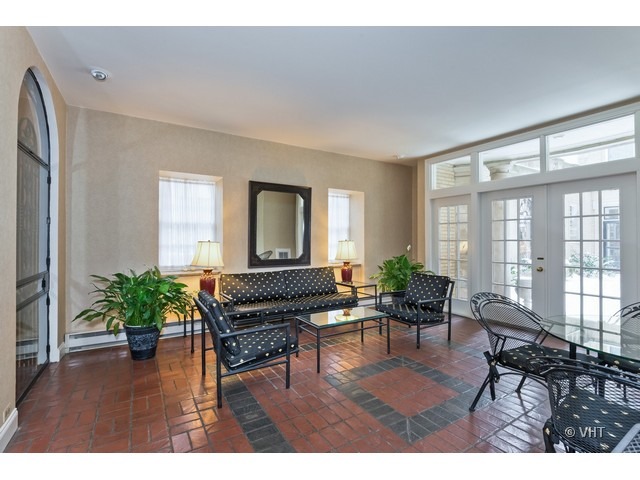 70 East Scott Street, Unit 408 Chicago, IL 60610 - Photo 2 of 9 a living room with furniture and a potted plant