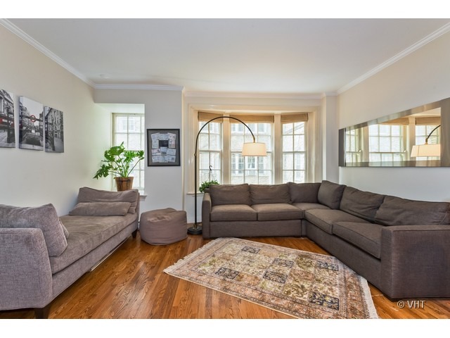 70 East Scott Street, Unit 408 Chicago, IL 60610 - Photo 3 of 9 a living room with furniture and a large window