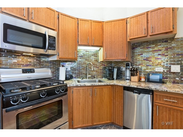 70 East Scott Street, Unit 408 Chicago, IL 60610 - Photo 4 of 9 a kitchen with stainless steel appliances a stove a sink and a microwave