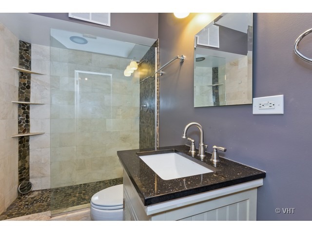 70 East Scott Street, Unit 408 Chicago, IL 60610 - Photo 7 of 9 a bathroom with a sink toilet and shower