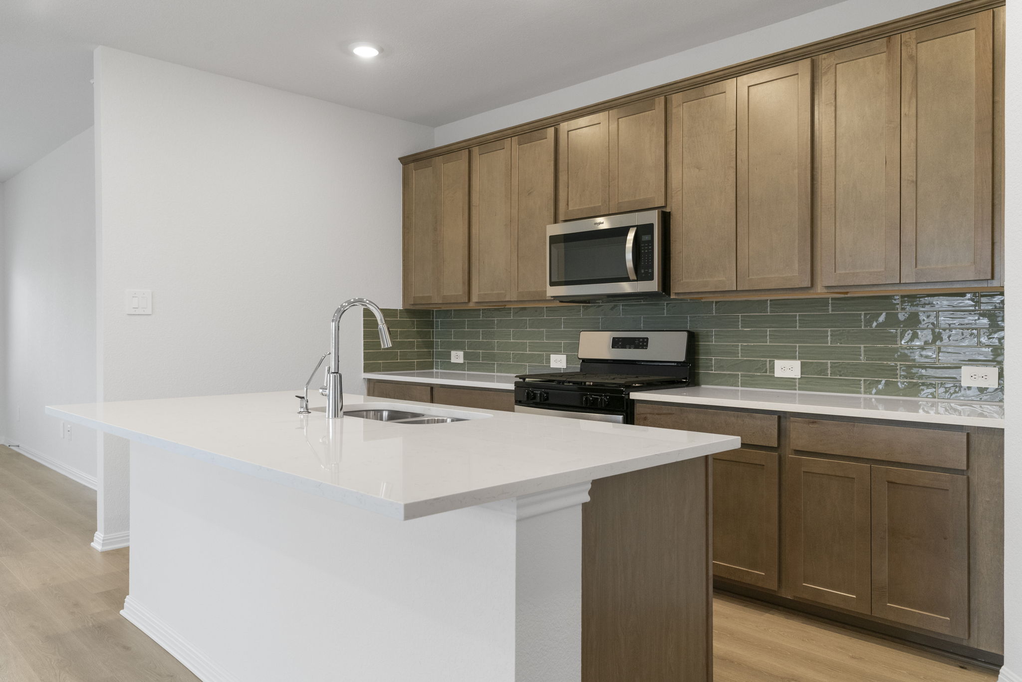 104 Boondoggle Ridge Cedar Creek, TX 78612 - Photo 11 of 33 a kitchen with stainless steel appliances a sink a stove a microwave a sink and cabinets