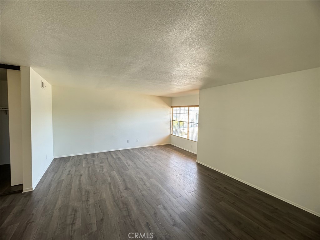 27515 Via Valor Dana Point, CA 92624 - Photo 15 of 24 an empty room with wooden floor and windows