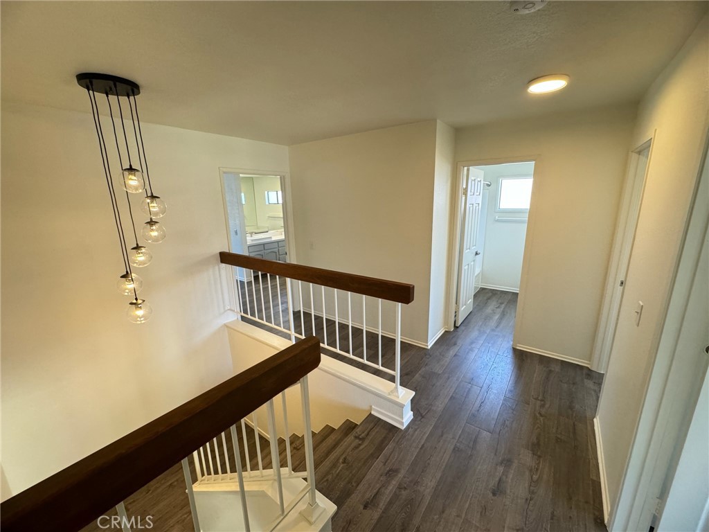 27515 Via Valor Dana Point, CA 92624 - Photo 10 of 24 a view of a hallway with wooden floor and staircase