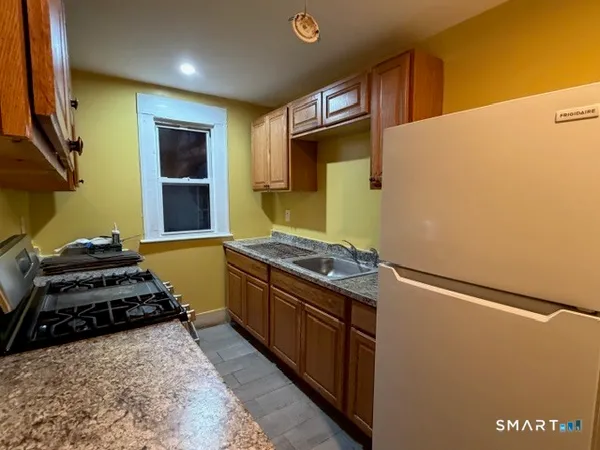 a kitchen with stainless steel appliances granite countertop a stove and a refrigerator