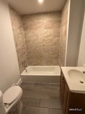 a bathroom with a sink a toilet and bathtub