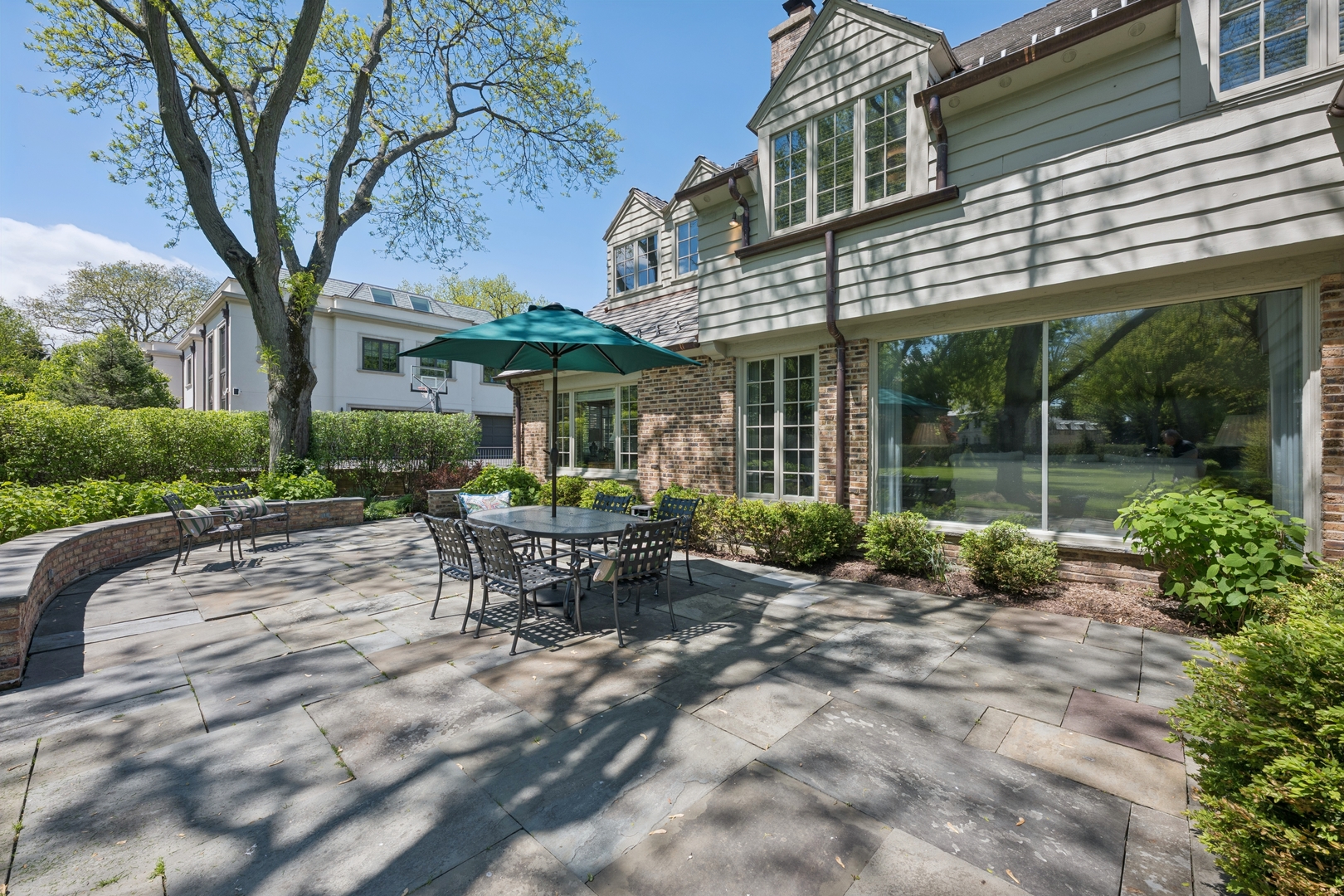 936 Sunset Road Winnetka, IL 60093 - Photo 12 of 50 a view of a house with backyard porch and sitting area