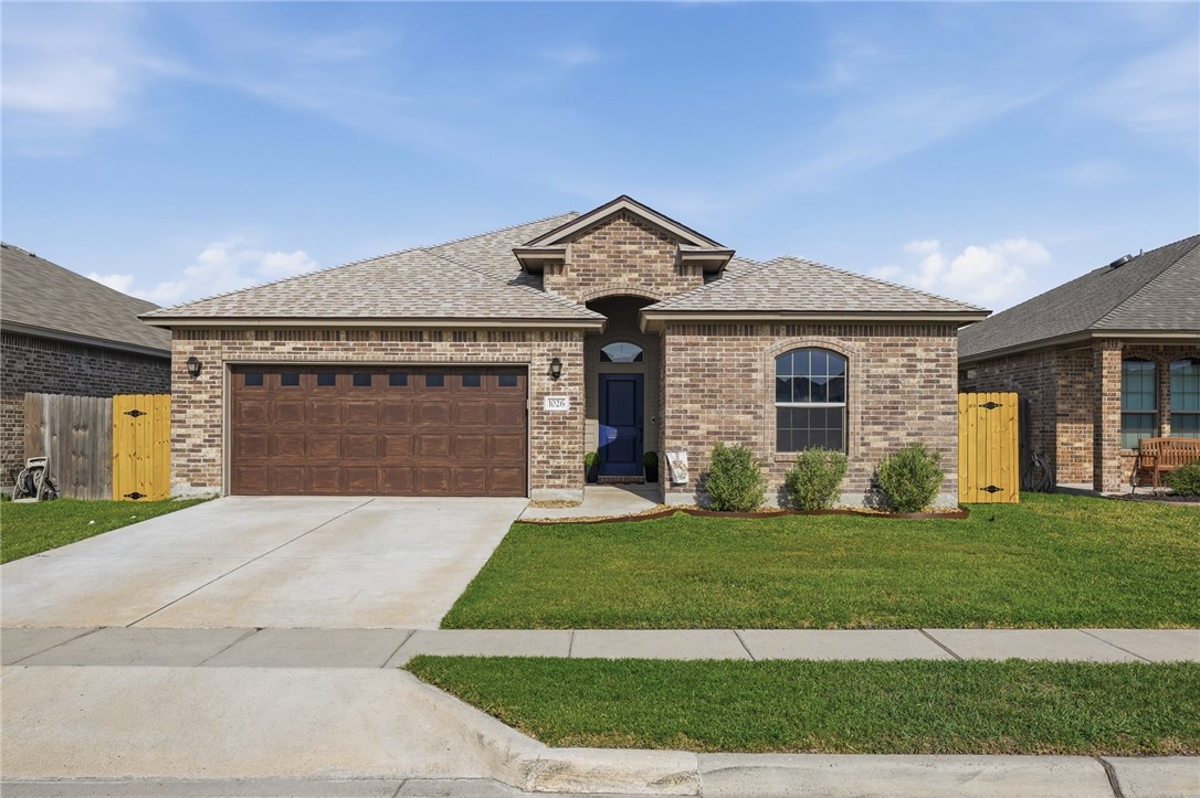 1026 Pasadena Street Portland, TX 78374 - Photo 1 of 30 a front view of a house with a yard and garage
