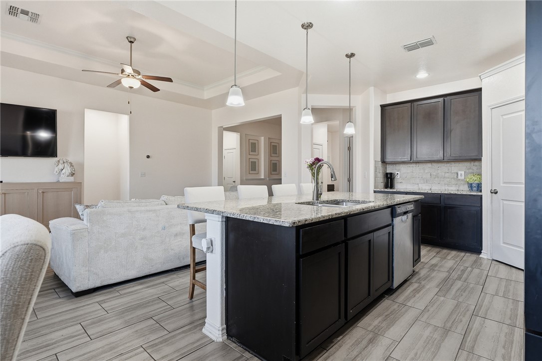1026 Pasadena Street Portland, TX 78374 - Photo 15 of 30 a kitchen with kitchen island granite countertop a sink counter top space and stainless steel appliances