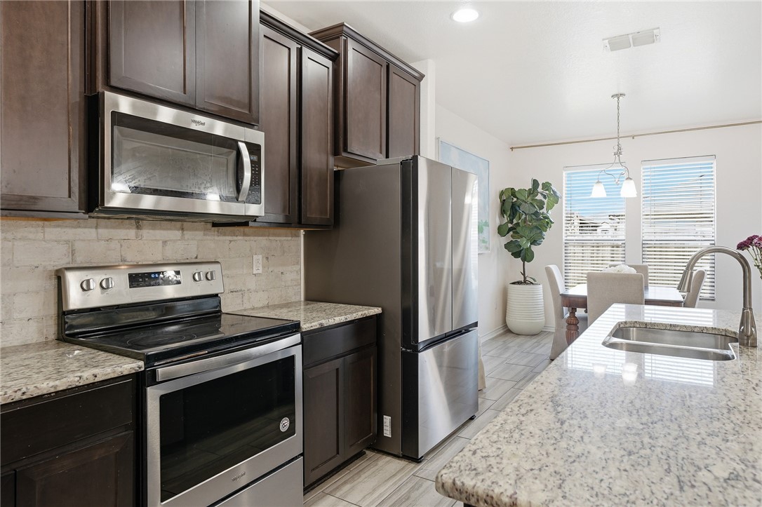 1026 Pasadena Street Portland, TX 78374 - Photo 16 of 30 a kitchen with a refrigerator stove and microwave