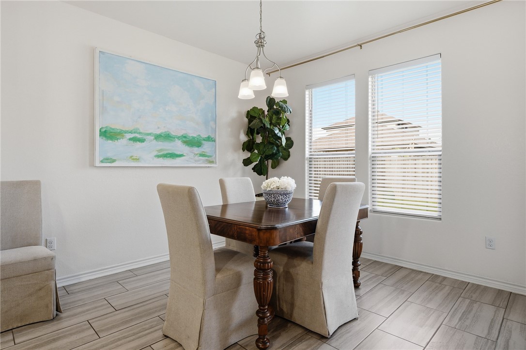 1026 Pasadena Street Portland, TX 78374 - Photo 17 of 30 a dining room with furniture potted plants and wooden floor
