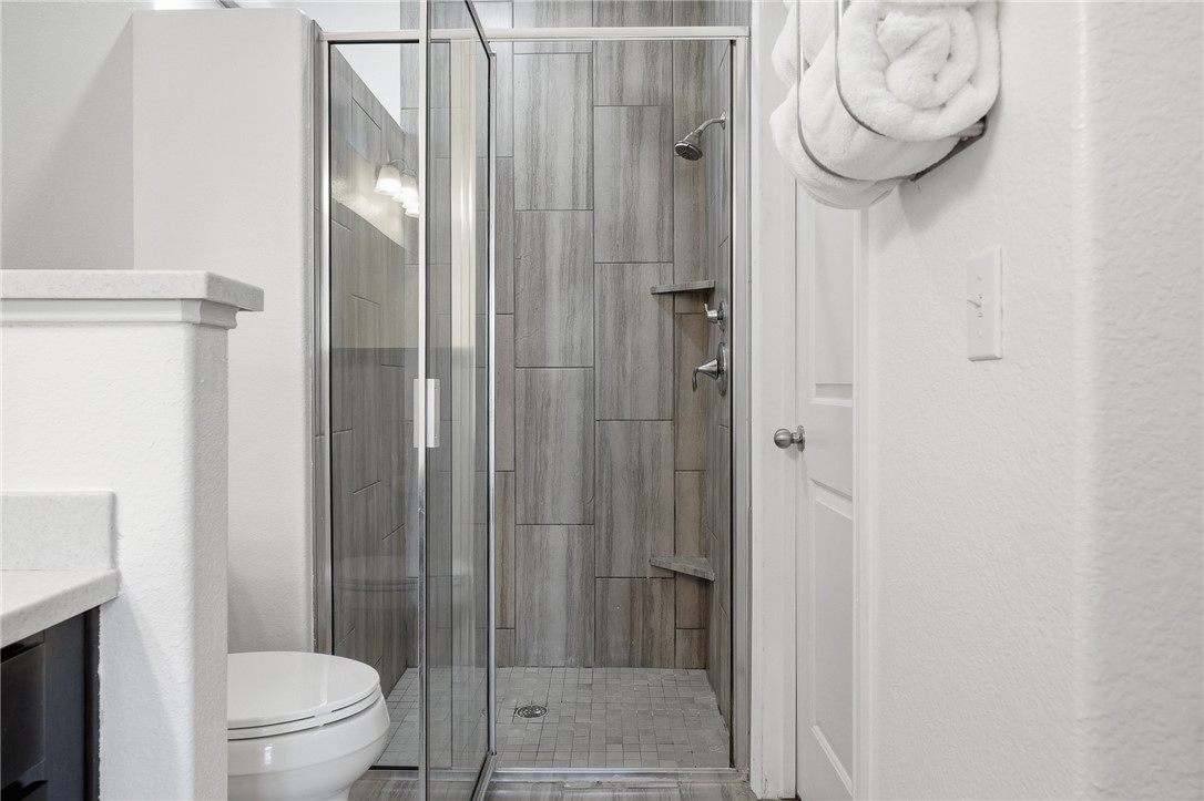 1026 Pasadena Street Portland, TX 78374 - Photo 21 of 30 a bathroom with a toilet and a shower