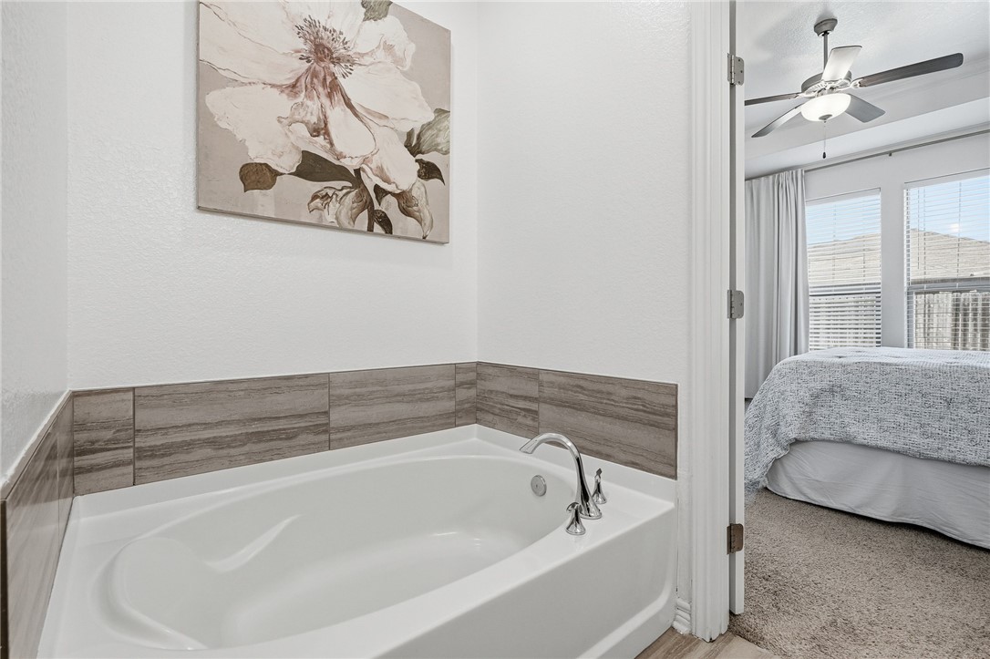 1026 Pasadena Street Portland, TX 78374 - Photo 22 of 30 a spacious bathroom with a bathtub and a window