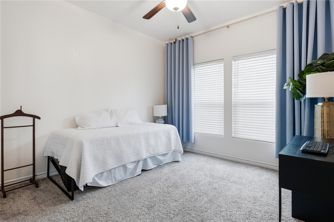 1026 Pasadena Street Portland, TX 78374 - Photo 23 of 30 a bedroom with a bed and a flat tv screen on the dresser