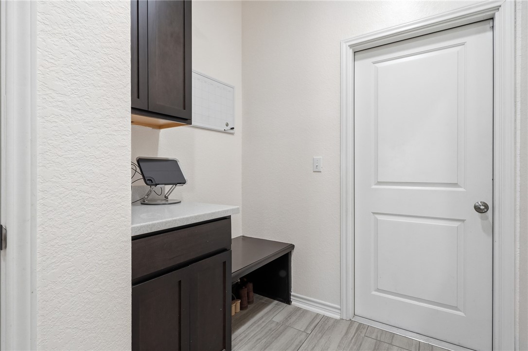 1026 Pasadena Street Portland, TX 78374 - Photo 25 of 30 a room with a bench and cabinets