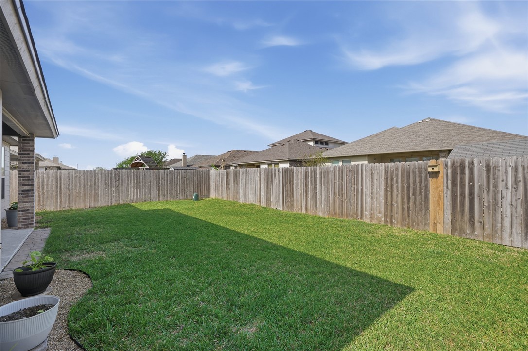 1026 Pasadena Street Portland, TX 78374 - Photo 30 of 30 a view of a backyard with table and chairs with wooden fence