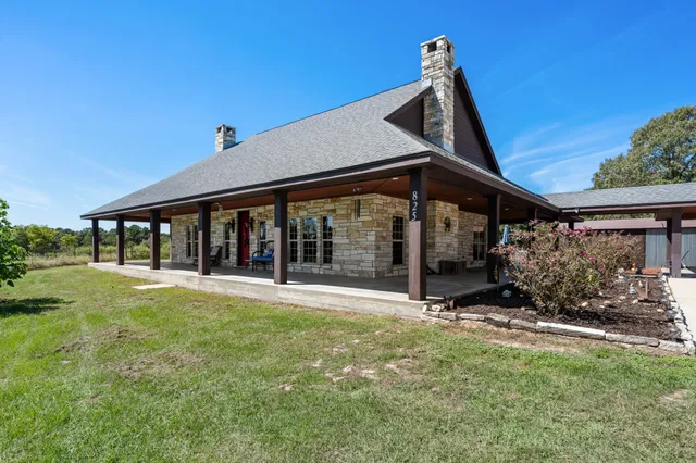 a view of an house with backyard porch and furniture