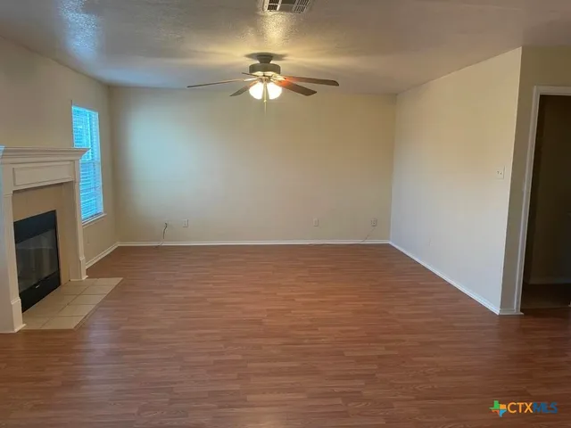 wooden floor in an empty room with a fireplace
