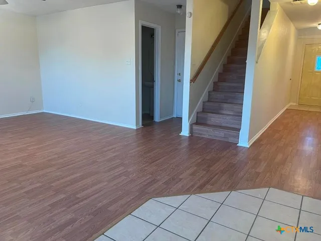a view of an entryway with wooden floor