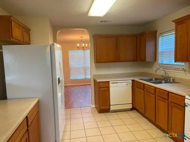 a kitchen with a sink a stove and cabinets