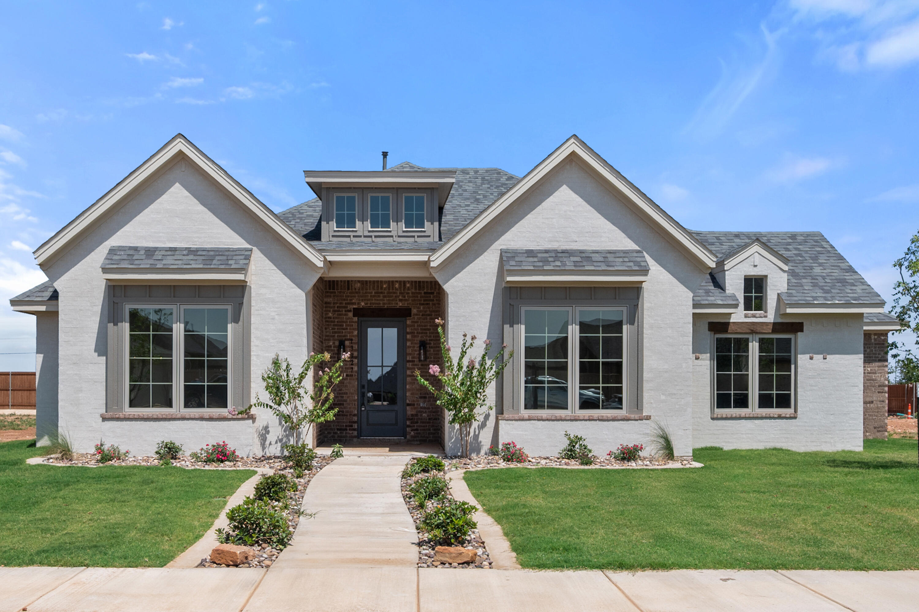 a view of a house with a yard and plants