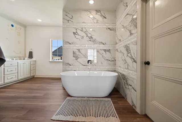 a spacious bathroom with a bathtub and shower