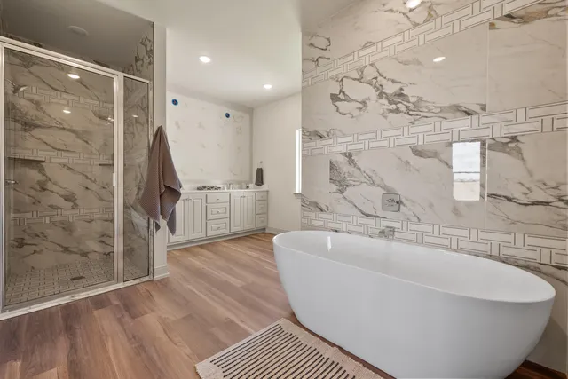 a bathroom with a bathtub and shower