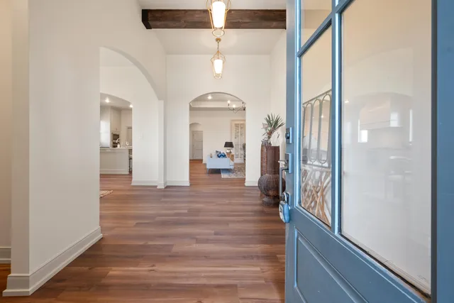 a view of a hallway view with wooden floor and staircase