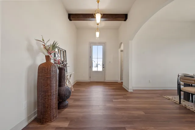 a view of entryway and hall with wooden floor