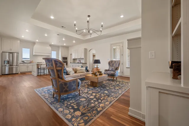 a living room with lots of furniture and kitchen view