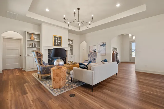 a living room with fireplace furniture and a wooden floor