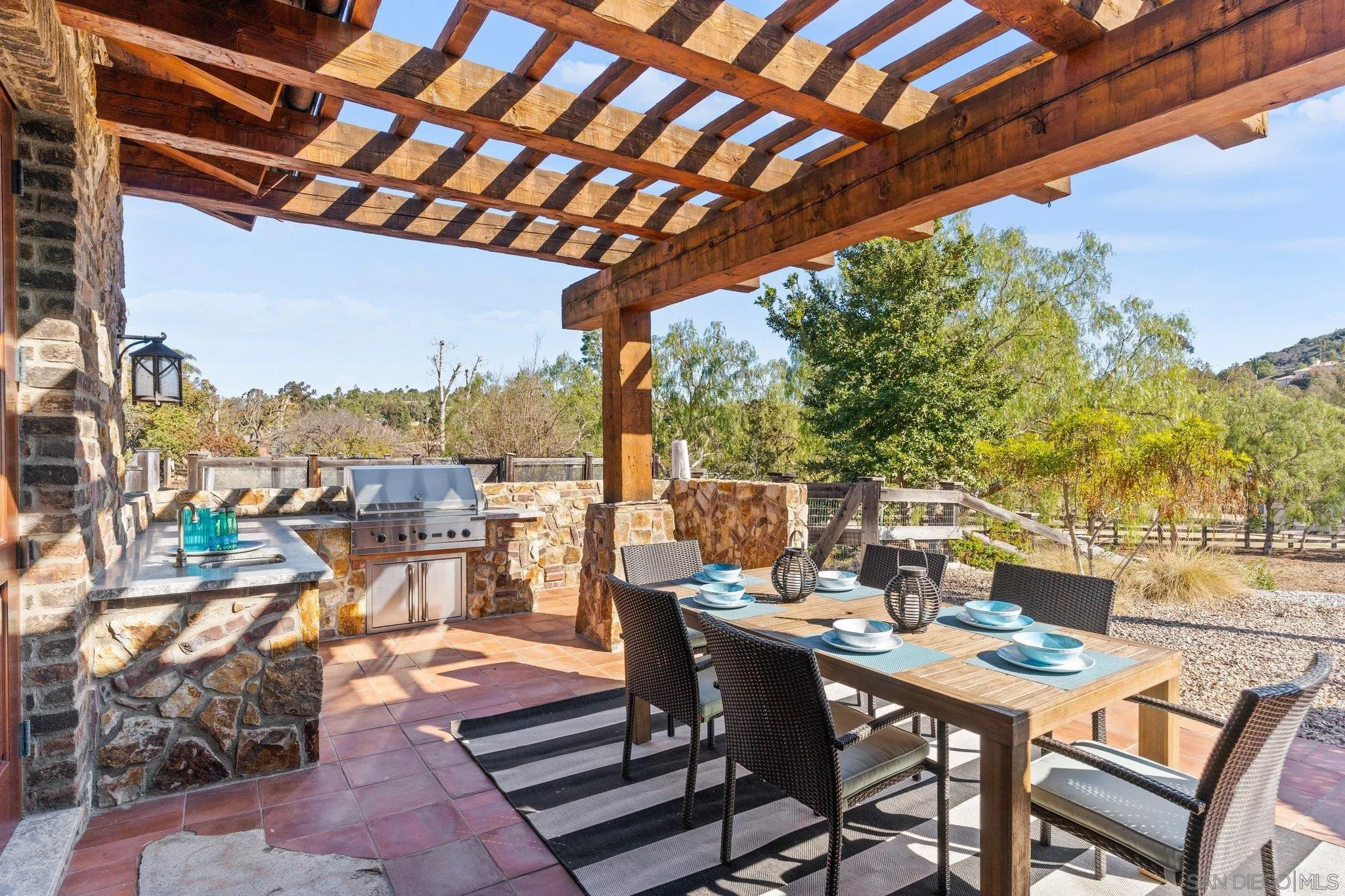 3113 Camino Del Rancho Encinitas, CA 92024 - Photo 19 of 40 a view of a patio with a table and chairs and potted plants