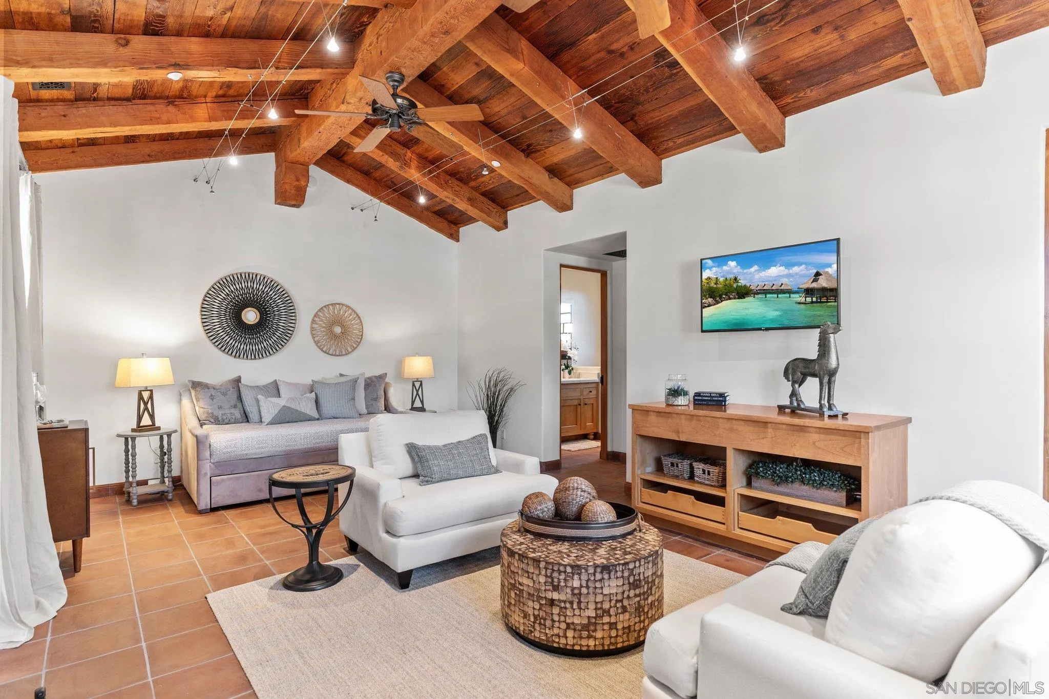 3113 Camino Del Rancho Encinitas, CA 92024 - Photo 23 of 40 a living room with furniture and a flat screen tv