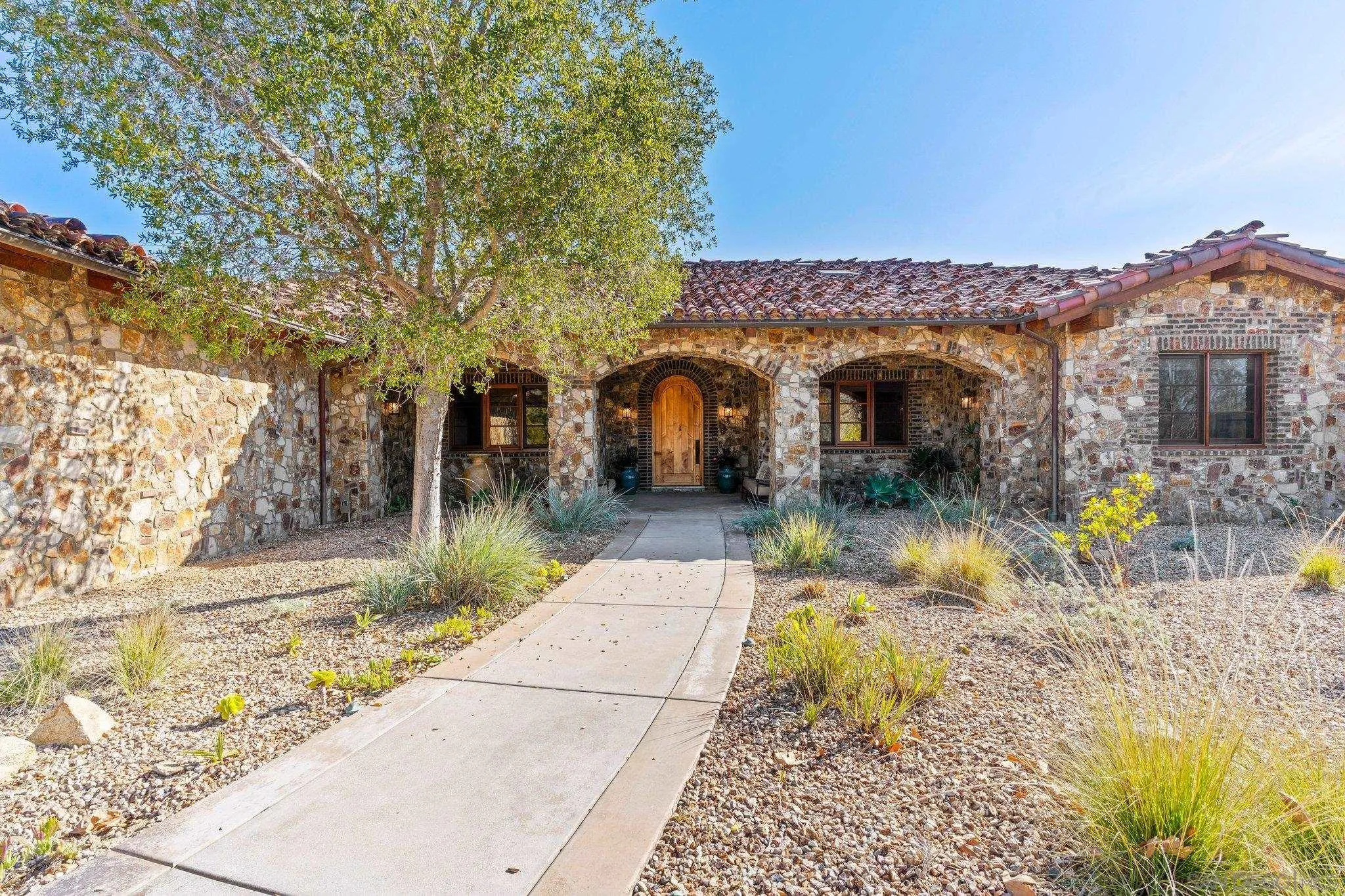 3113 Camino Del Rancho Encinitas, CA 92024 - Photo 3 of 40 a front view of a house with garden