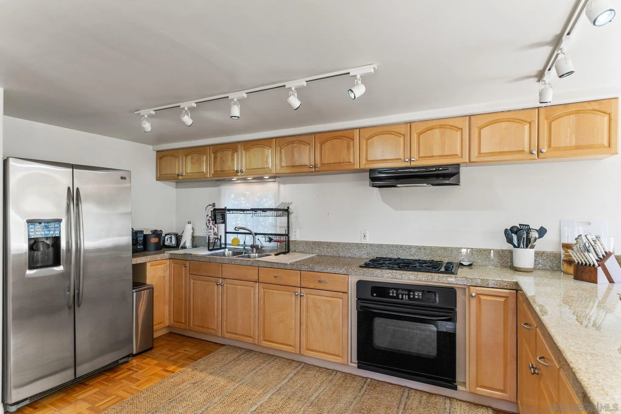 3113 Camino Del Rancho Encinitas, CA 92024 - Photo 31 of 40 a kitchen with stainless steel appliances granite countertop a sink a stove and refrigerator