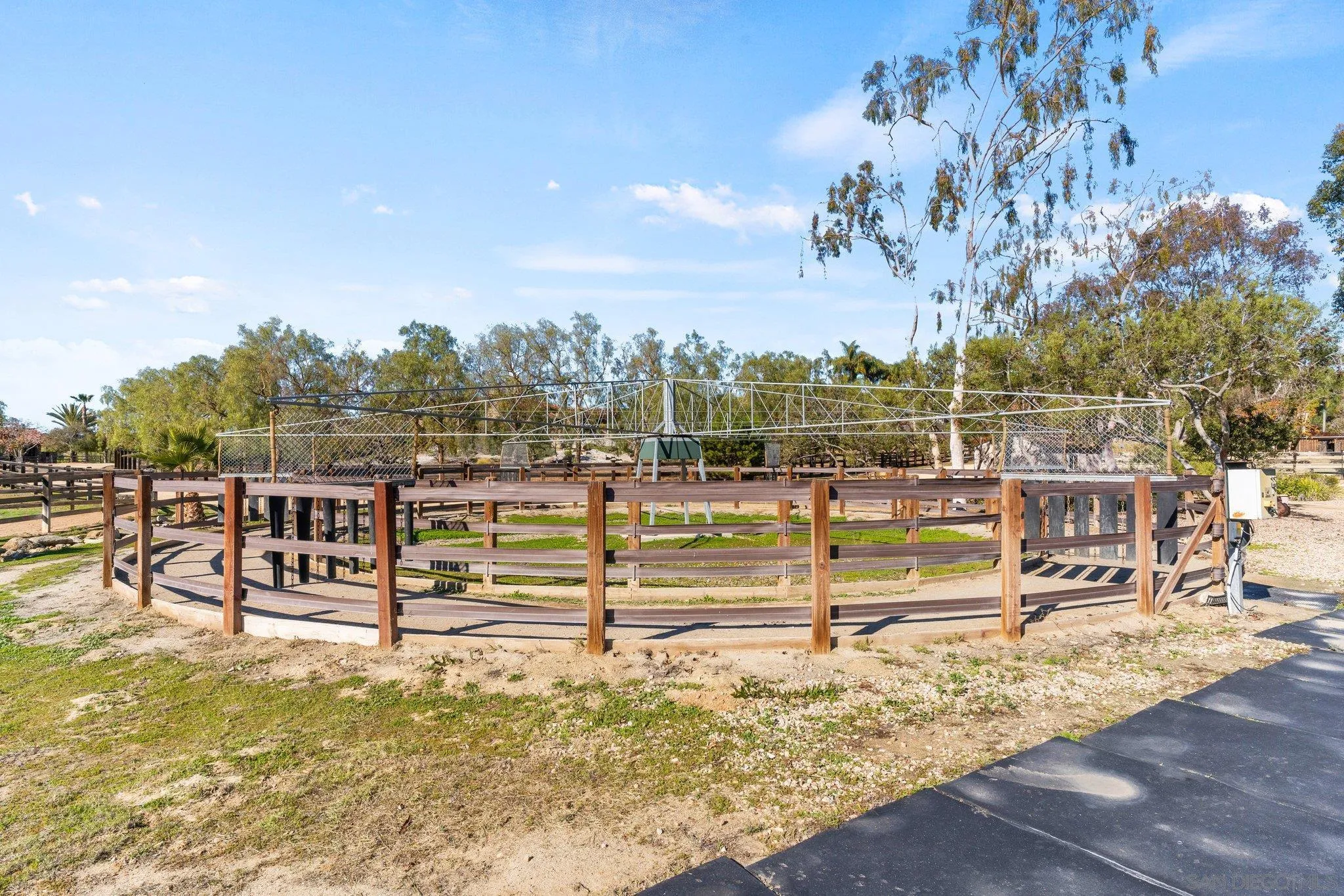 3113 Camino Del Rancho Encinitas, CA 92024 - Photo 35 of 40 a view of a swimming pool with outdoor seating and trees in the background