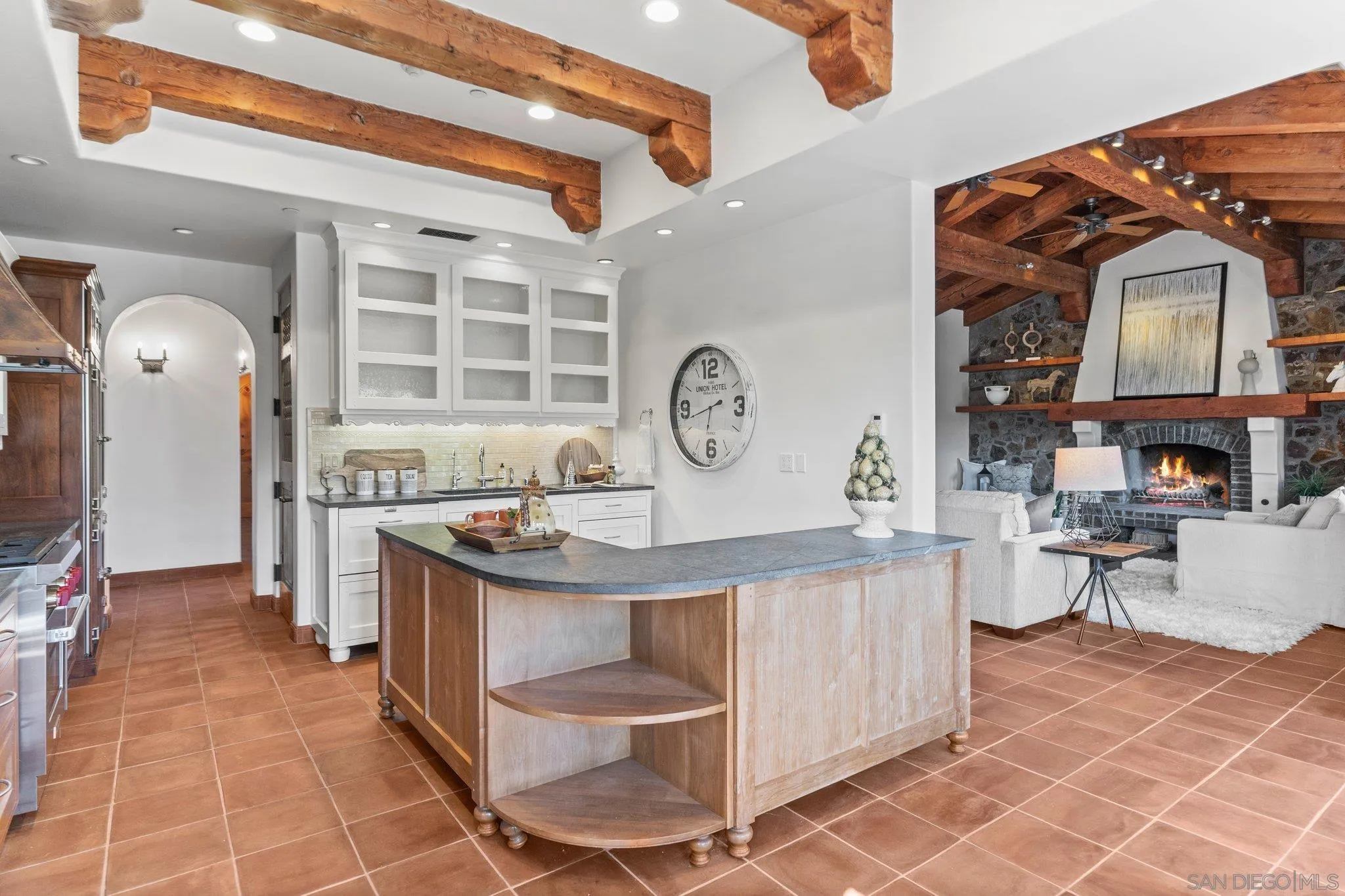 3113 Camino Del Rancho Encinitas, CA 92024 - Photo 10 of 40 a kitchen with stainless steel appliances a stove a chimney a sink and cabinets