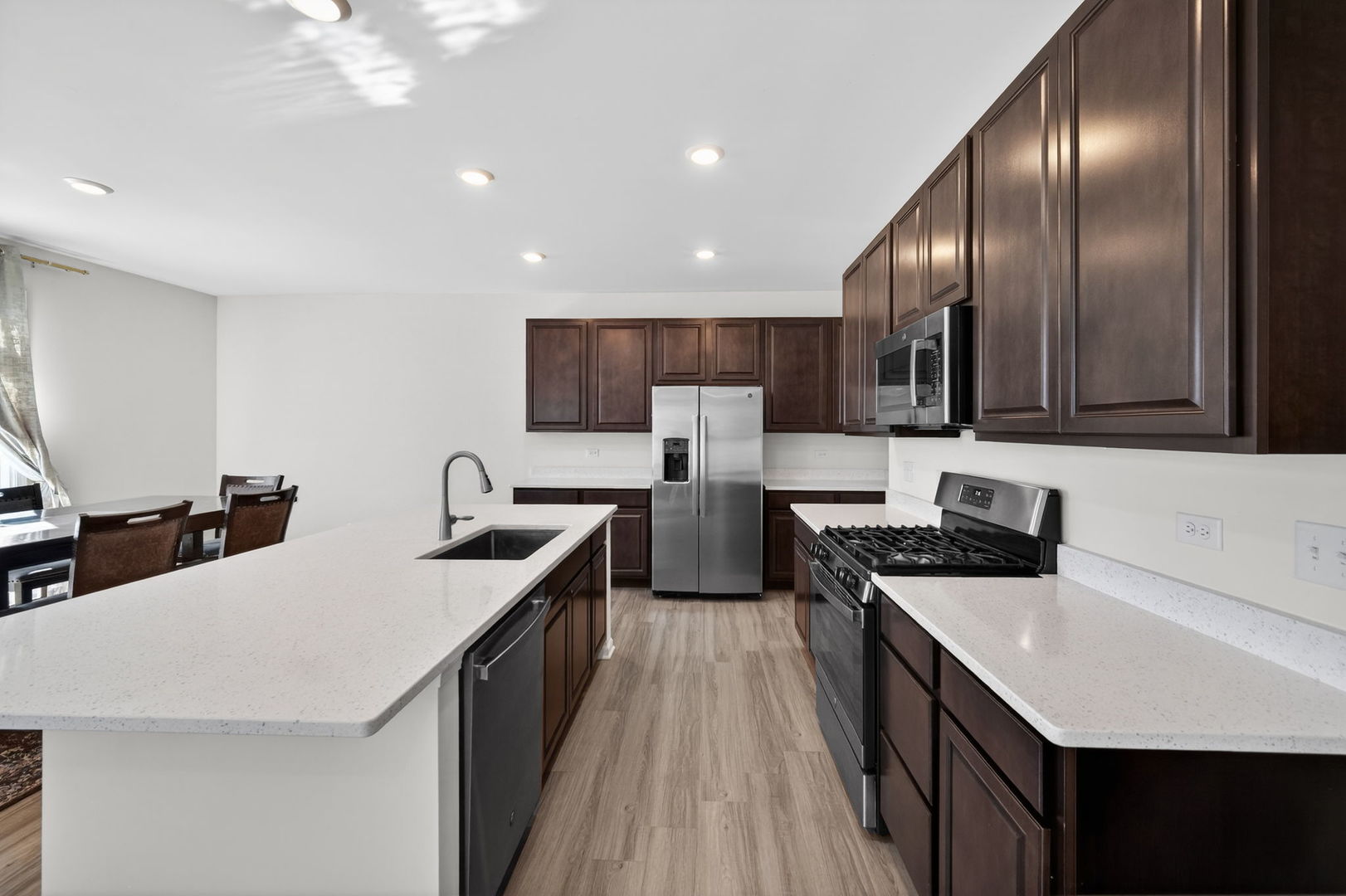 3803 Ivy Lane Elgin, IL 60124 - Photo 12 of 43 a kitchen with stainless steel appliances a sink stove and refrigerator