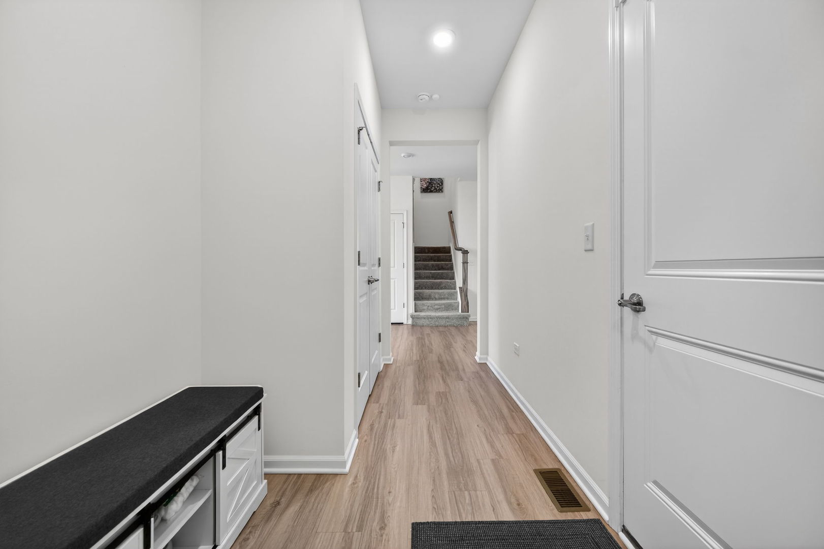 3803 Ivy Lane Elgin, IL 60124 - Photo 29 of 43 a view of a hallway with wooden floor and staircase