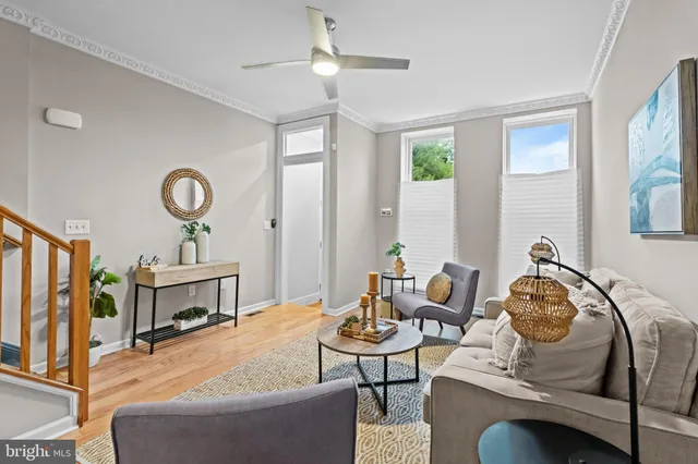 a living room with furniture a fireplace and a window