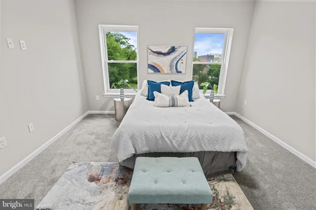 a bed sitting in a bedroom next to a window