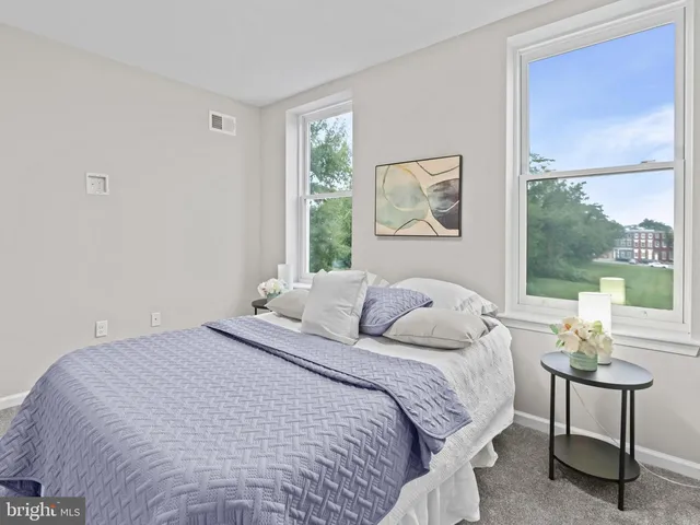 a bedroom with a bed and window