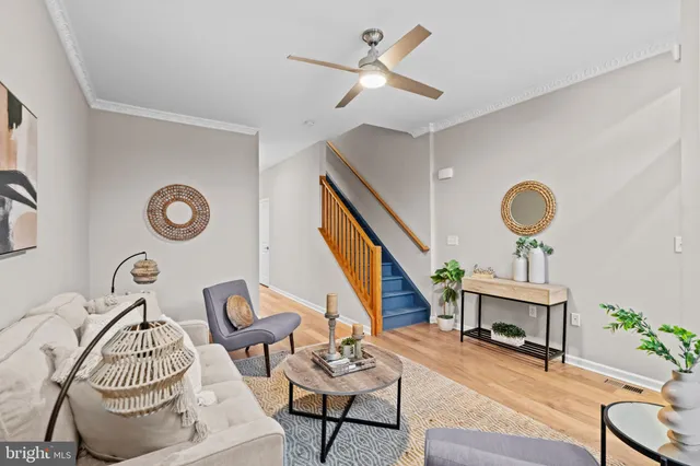 a living room with furniture a rug and a window