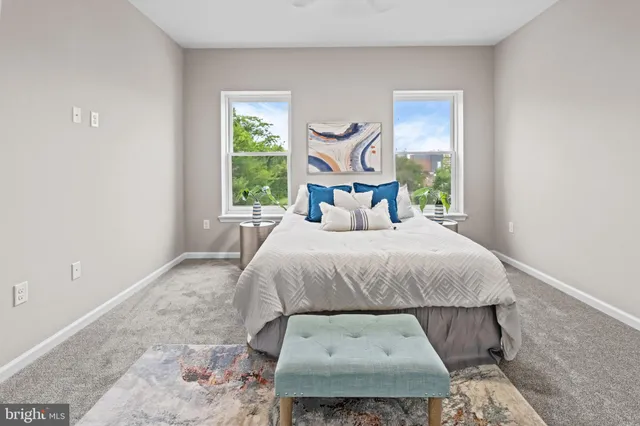 a bedroom with a bed a mirror and a window