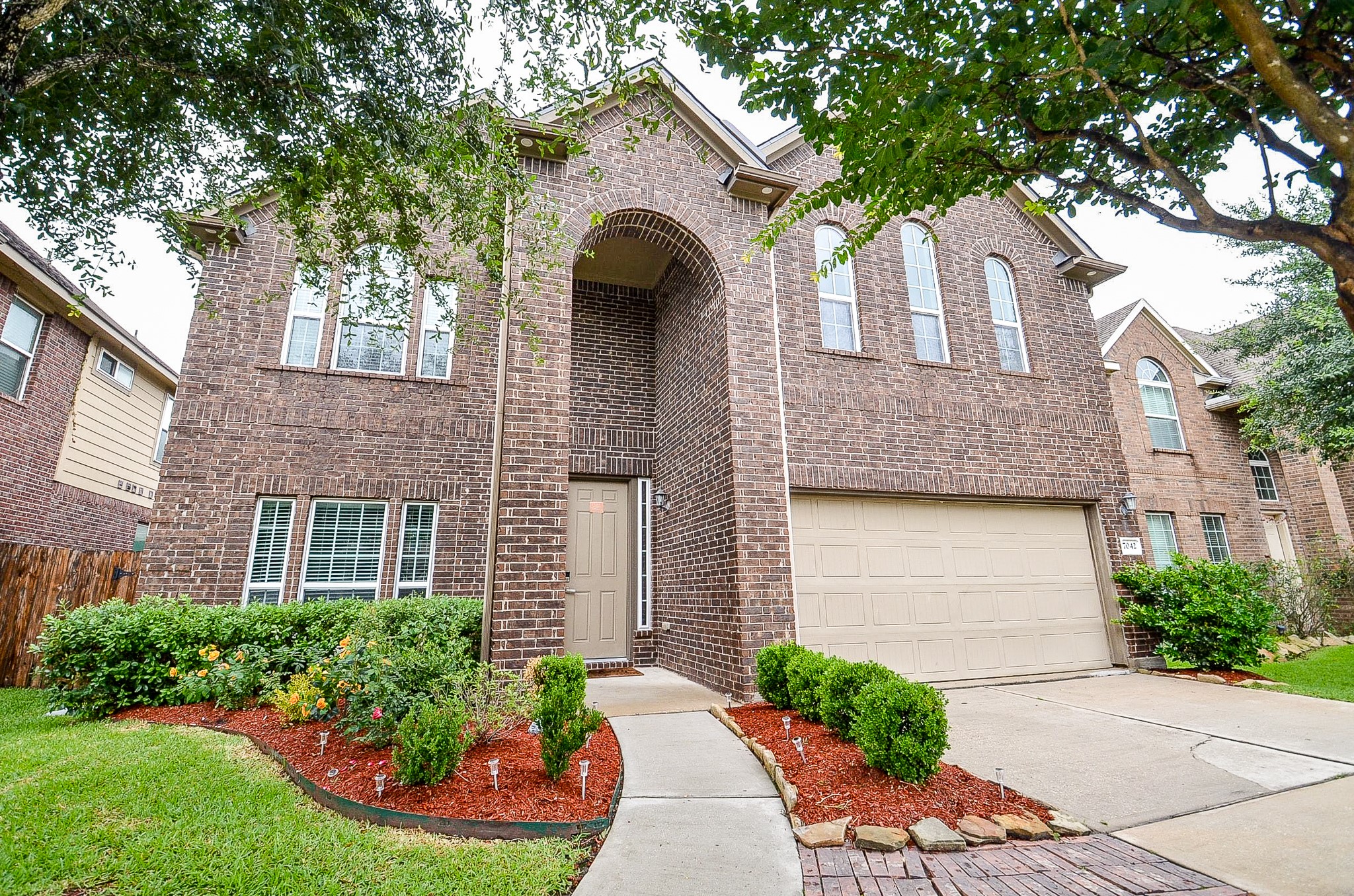 7042 Sliding Rock Circle Spring, TX 77379 - Photo 2 of 36 Beautifully manicured landscaping enhances the home's welcoming curb appeal.