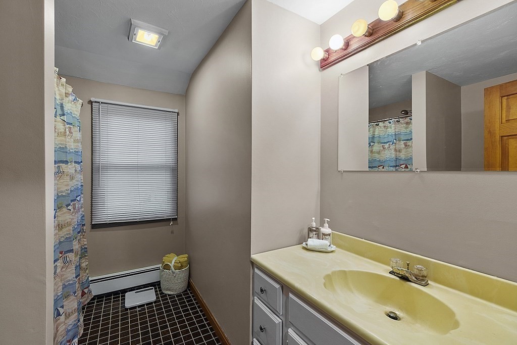 376 Littleton Road Chelmsford, MA 01824 - Photo 24 of 35 a bathroom with a sink and a mirror