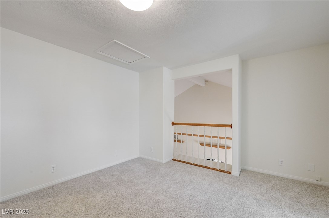 2955 El Camino Road Las Vegas, NV 89146 - Photo 65 of 99 Carpeted spare room featuring attic access and lofted ceiling