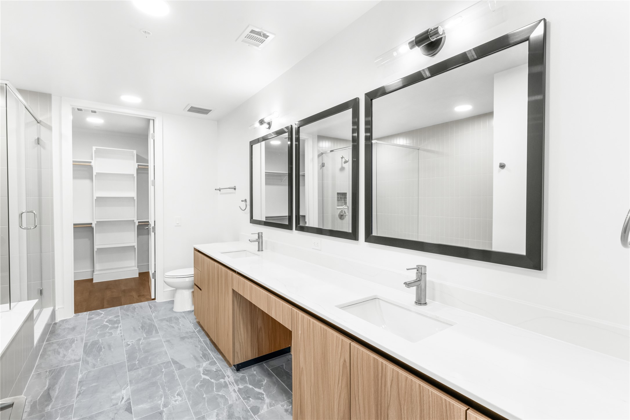 2311 Westheimer Road, Unit 914 Houston, TX 77098 - Photo 14 of 29 a bathroom with a double vanity sink mirror and double