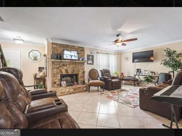 a living room with furniture a fireplace and a flat screen tv